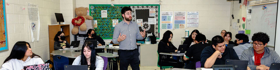 Teacher speaks to a classroom of students.