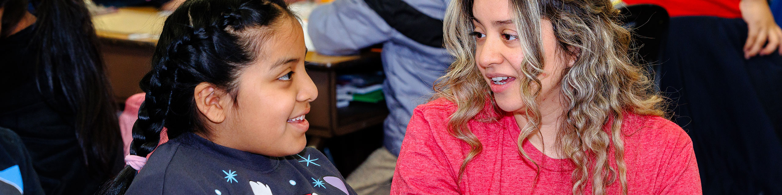 Student teacher helping a student on a project.