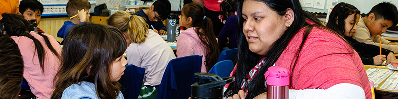 Teacher talking with a student in classroom