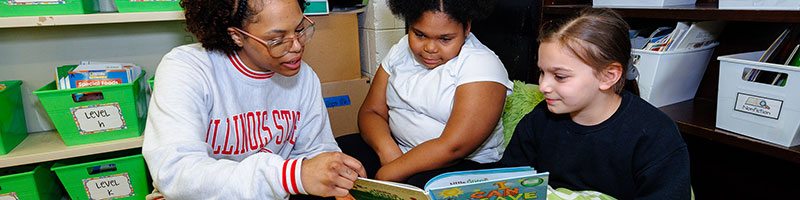 A teacher reading with students.