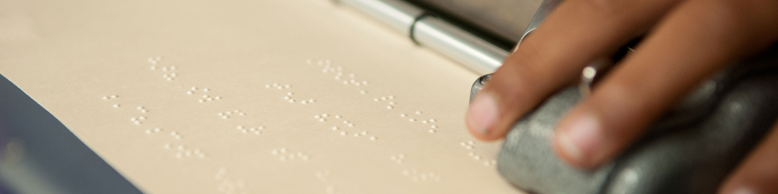 Student working on a braille machine.