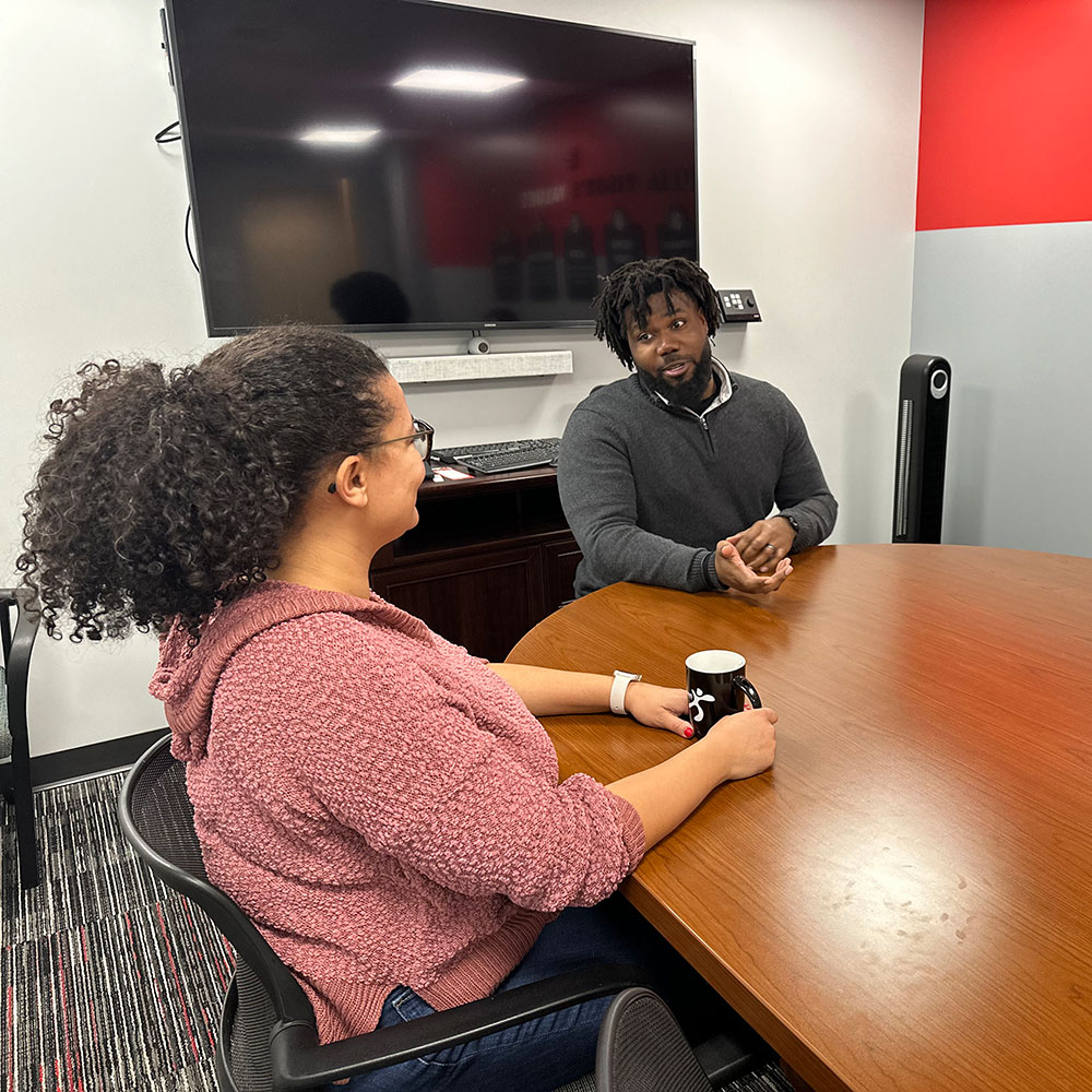 Staff talking in a meeting room